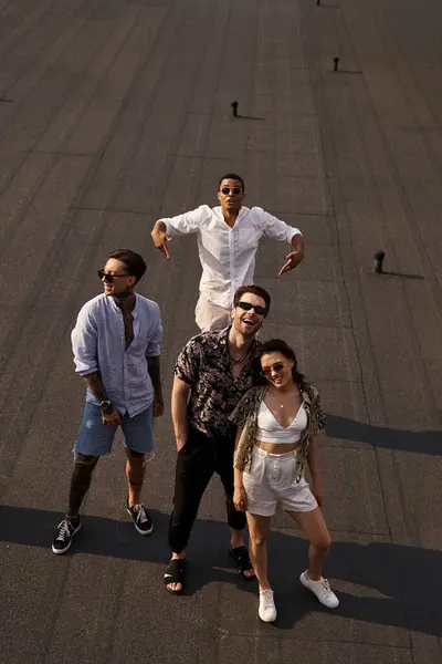 Joyous diverse friends with stylish sunglasses posing on rooftop together and looking at camera — Stock Photo