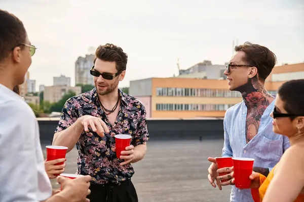 Good looking joyous interracial friends in casual attires spending time together at rooftop party — Stock Photo