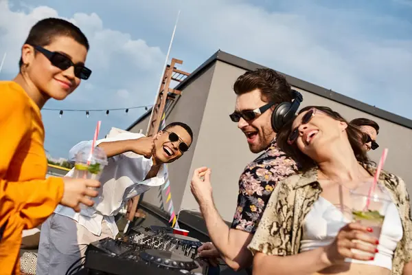 Interracial cheerful friends with sunglasses drinking and having fun at party and looking at camera — Stock Photo