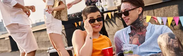 Joyous multiracial friends enjoying alcohol cocktails at rooftop party with DJ on backdrop, banner — Stock Photo