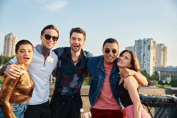 Good looking jolly multiracial friends posing together on rooftop and smiling happily at camera — Stock Photo