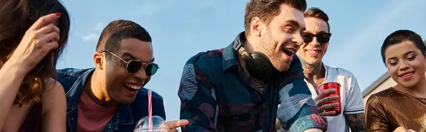 Cheerful interracial men and women dancing at rooftop party with DJ and drinking cocktails, banner — Stock Photo