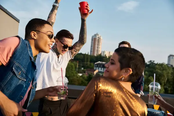 Merry diverse friends with sunglasses in vivid clothes drinking cocktails and having fun at party — Stock Photo