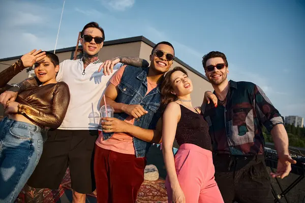 Cheerful good looking multicultural people in stylish attires smiling at camera at rooftop party — Stock Photo