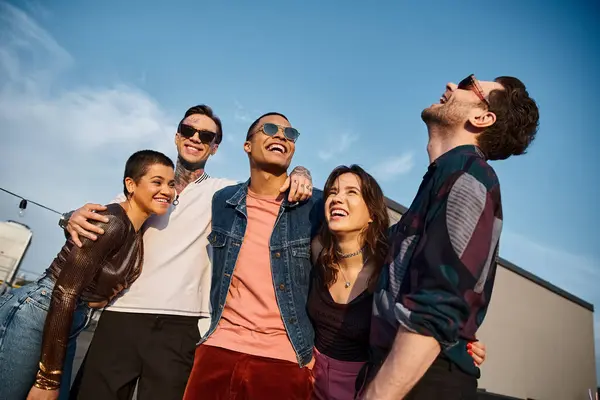 Cheerful multicultural friends with fashionable sunglasses having fun together at rooftop party — Stock Photo