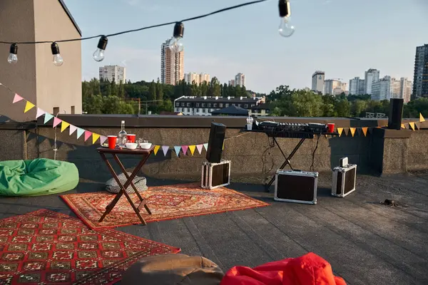 Object photo of outdoor terrace rooftop with vibrant carpets and DJ equipment with party details — Stock Photo