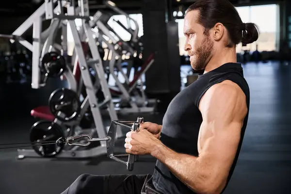 Un homme athlétique en tenue active tirant tout en travaillant dans une salle de gym. — Photo de stock