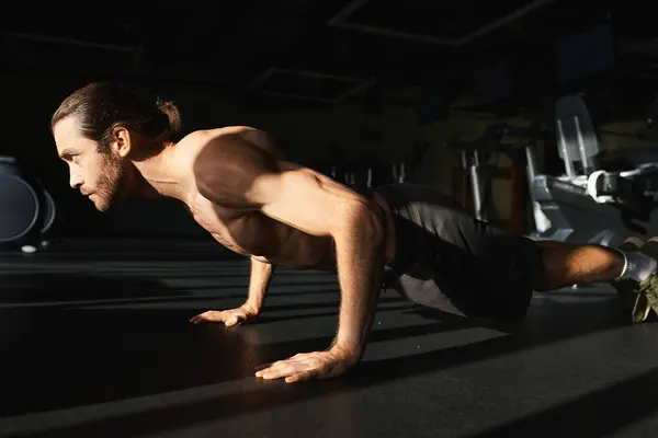 Muscular shirtless man doing push ups in a gym. — Stock Photo