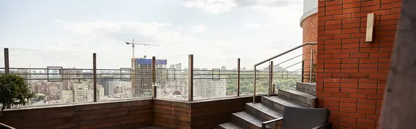Un tranquilo balcón enmarcado por una pared de ladrillo texturizado y una elegante barandilla metálica, que ofrece un espacio sereno con un toque de encanto - foto de stock