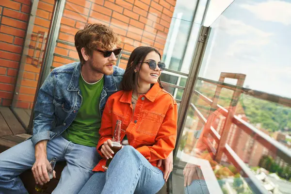 A man and a woman are peacefully sitting side by side on a weathered wooden bench in a serene park setting — Stock Photo