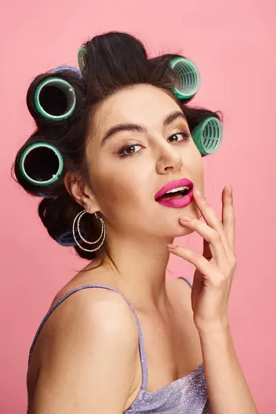 Una donna con i bigodini nei capelli che si prepara per un look glamour. — Foto stock