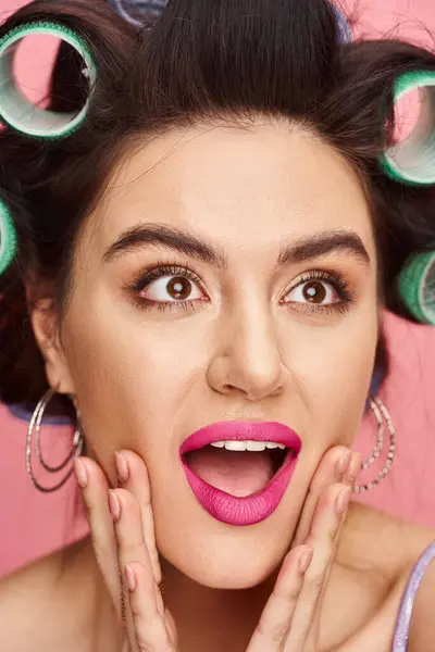 Stylish woman with curlers in hair and bright pink lipstick. — Stock Photo