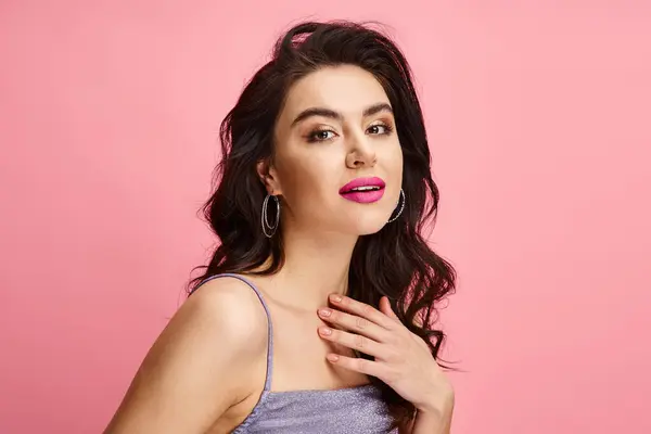 A natural beauty woman with long dark hair and pink lipstick posing on a vibrant backdrop. — Stock Photo
