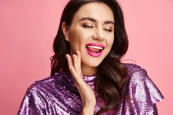A woman exudes charm in a purple sequin top and pink lipstick. — Stock Photo