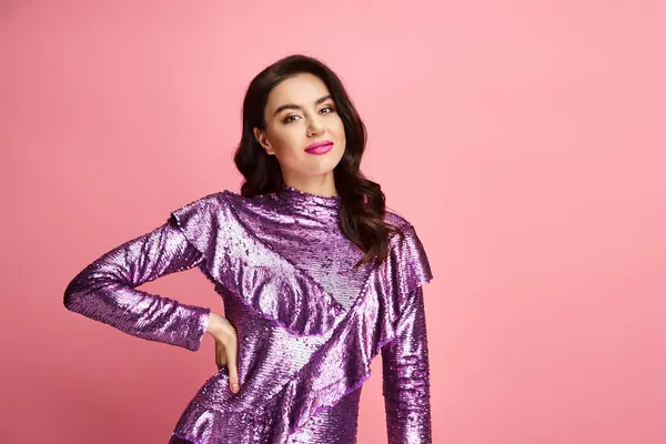 A woman with natural beauty poses in a purple dress against a vibrant backdrop. — Stock Photo
