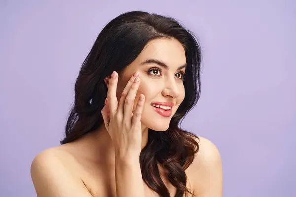 A stunning woman with flawless skin posing with hands delicately touching her face. — Stock Photo