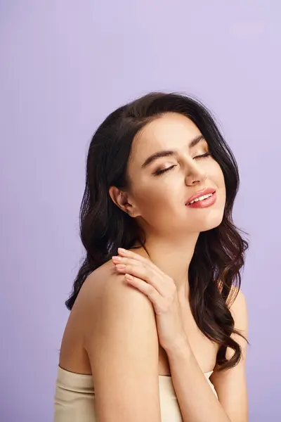 A woman standing with hands on chest, exhibiting self-care and beauty routine. — Stock Photo