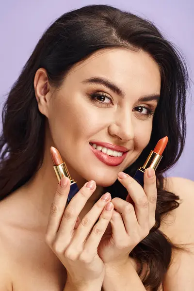 A woman creatively poses with two lipsticks adorning her face. — Stock Photo