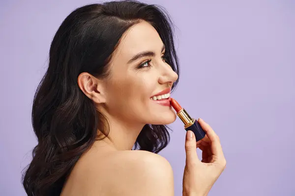 A woman enhancing her natural beauty with a lipstick tube. — Stock Photo
