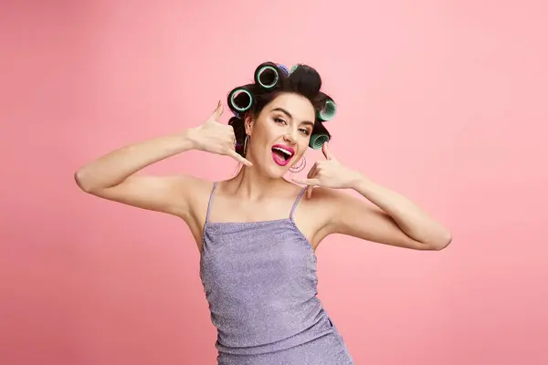 Stylish woman with curlers in hair, holding her luscious locks. — Stock Photo