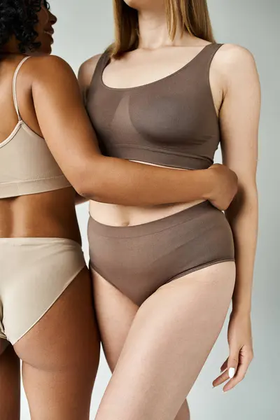 Two diverse women in cozy pastel underwear standing side by side. — Stock Photo