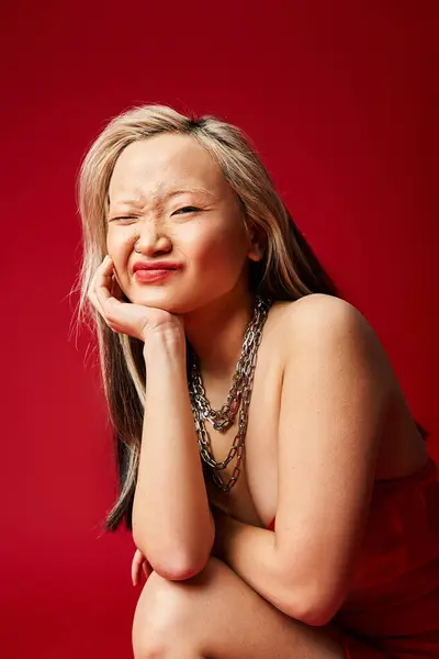 Asian woman in a striking red dress strikes a pose for the camera. — Stock Photo