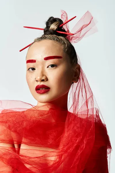 Asian woman adorned in red makeup and a veil, exuding mystery and elegance. — Stock Photo