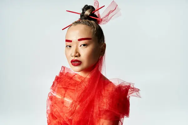 An enticing Asian woman adorned in red makeup and a flowing veil. — Stock Photo