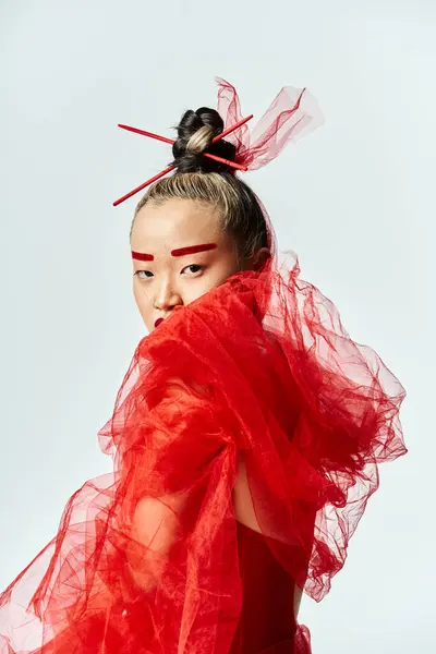 Asian woman in vibrant red dress and veil posing elegantly. — Stock Photo