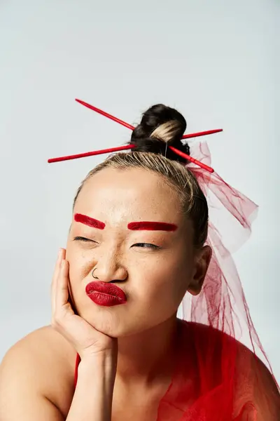 Asian woman in vibrant attire, adorned in red makeup and veil. — Stock Photo