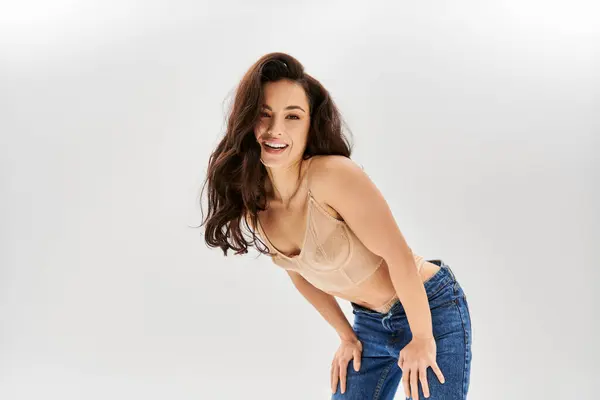 A young woman in lingerie striking a sultry pose with her hands on her hips. — Stock Photo