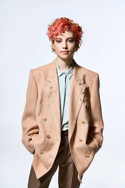 Stylish woman with red hair wearing a striking jacket and pants. — Stock Photo