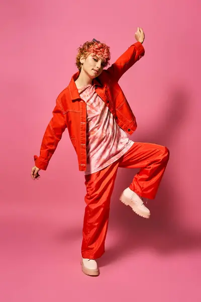 Extraordinary woman in a vibrant crimson suit gracefully kicks in mid-air. — Stock Photo