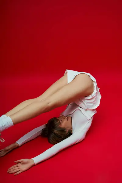 Giovane donna in abito bianco che mostra forza ed equilibrio con una paletta. — Foto stock