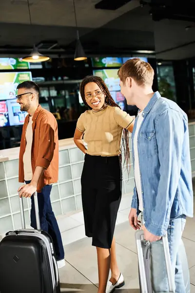 Multicultural group of businesspeople in casual clothes standing with luggage in hotel lobby during corporate trip. — Stock Photo