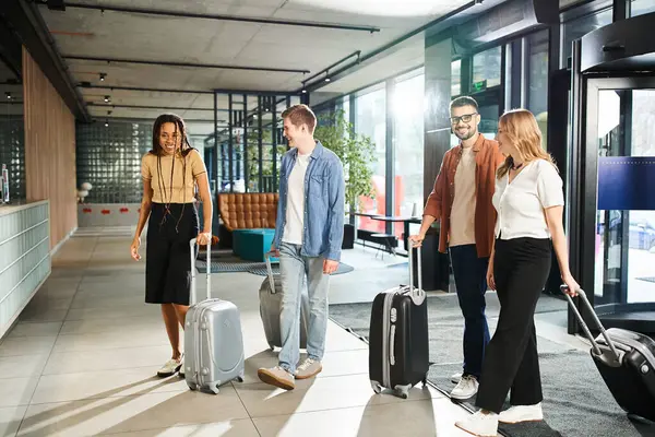 Multicultural colleagues with luggage gather in hotel lobby during corporate trip. Diverse businesspeople in casual clothes. — Stock Photo