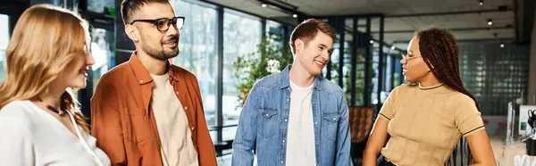 Multicultural colleagues in casual attire stand together in a hotel lobby during a corporate trip. — Stock Photo