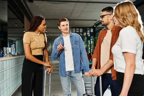 Diverse group of businesspeople in casual attire, standing together in a hotel lobby with their luggage, ready for a corporate trip. — Stock Photo