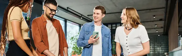 A diverse group of businesspeople, dressed casually, standing together in a hotel lobby during a corporate trip. — Stock Photo