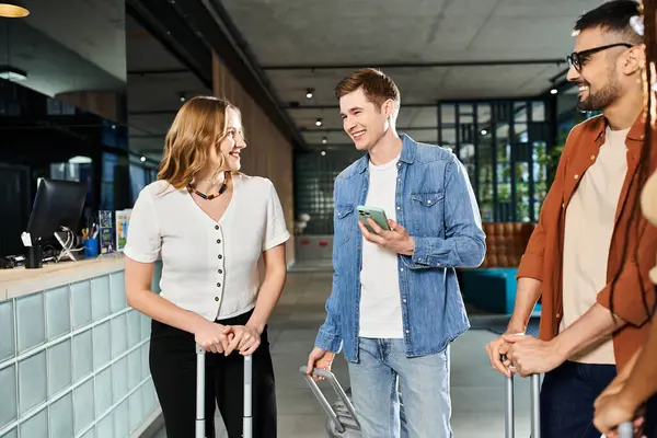 Diverse group of businesspeople standing together in a hotel lobby, holding luggage and engaging in conversation. — Stock Photo
