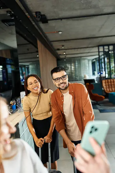 Multicultural colleagues stand in hotel lobby on corporate trip, diverse businesspeople in casual clothes. — Stock Photo