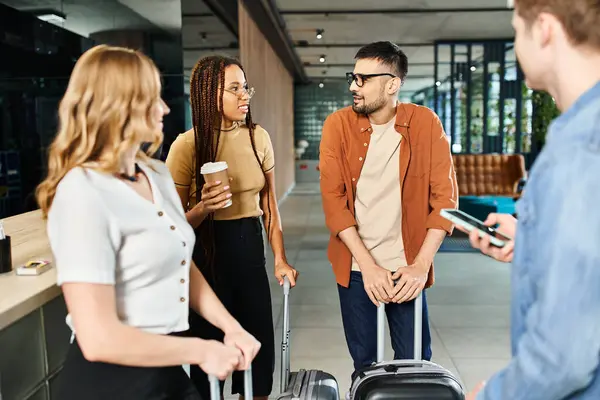 A group of diverse businesspeople in casual attire stand together in a hotel lobby with their luggage, ready for a trip. — Stock Photo