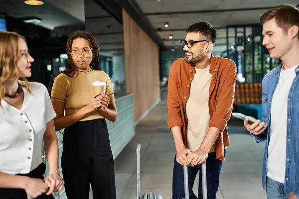 Diverse businesspeople in casual attire standing in a circle, discussing in a hotel lobby during a corporate trip. — Stock Photo