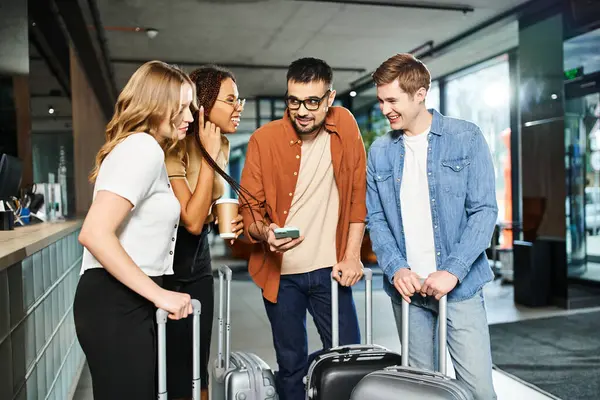 Multicultural colleagues in a hotel lobby, standing with luggage, preparing for a corporate trip. — Stock Photo