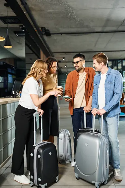 Multicultural colleagues in casual attire gather with luggage in a hotel lobby during a corporate trip. — Stock Photo