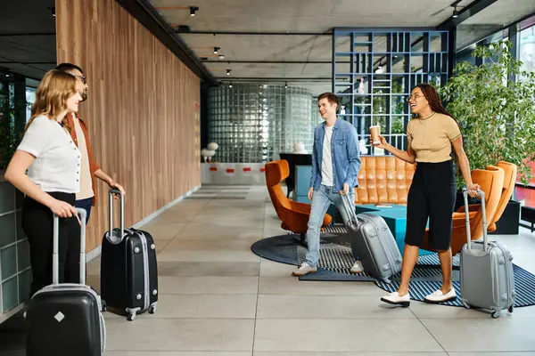 Multicultural colleagues in casual clothes gather with luggage in hotel lobby during corporate trip, ready to explore. — Stock Photo