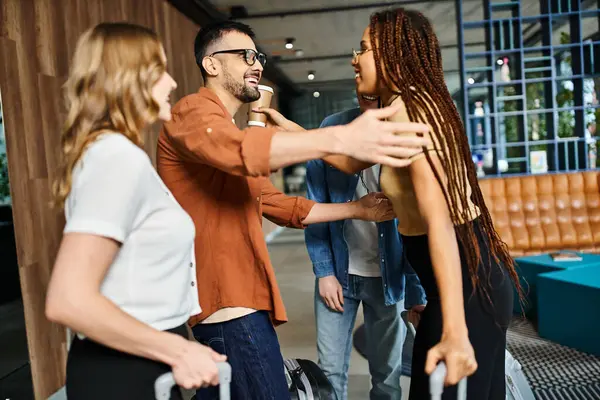 Multicultural colleagues in casual clothes stand in a circle engaging in greeting each other in hotel — Stock Photo