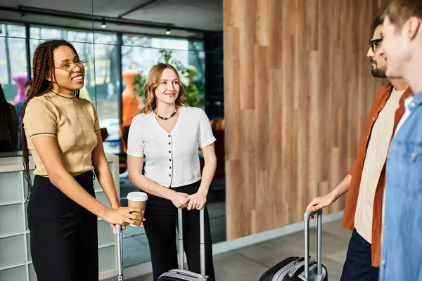 Multicultural colleagues in casual attire, standing around with luggage in a hotel lobby during a corporate trip. — Stock Photo