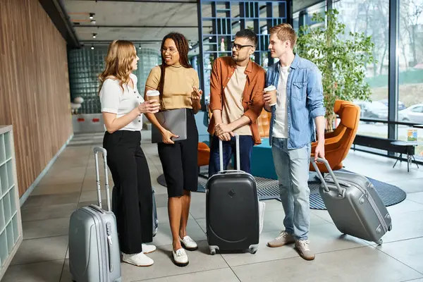 A diverse group of colleagues in casual attire standing together with luggage in a hotel lobby during a corporate trip. — Stock Photo