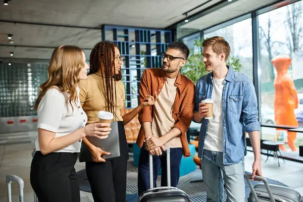 A diverse group of businesspeople in casual clothes stand together in a hotel lobby during a corporate trip. — Stock Photo